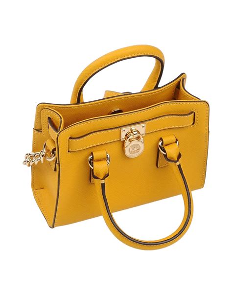 michael kors yellow handbag with studs|Michael Kors studded crossbody bag.